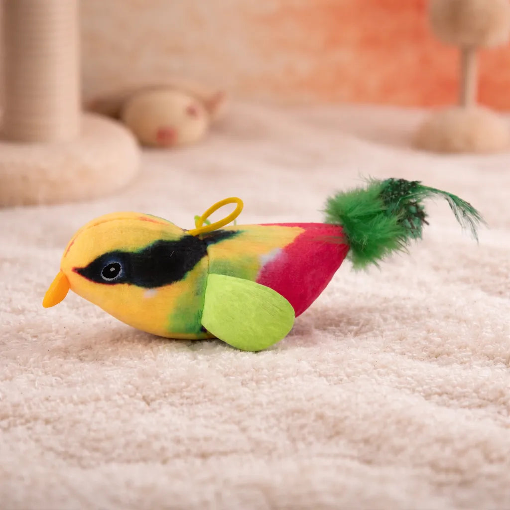 Colorful plush bird cat toy with yellow, red, and green accents, a black eye, orange beak, and green feathered tail.
