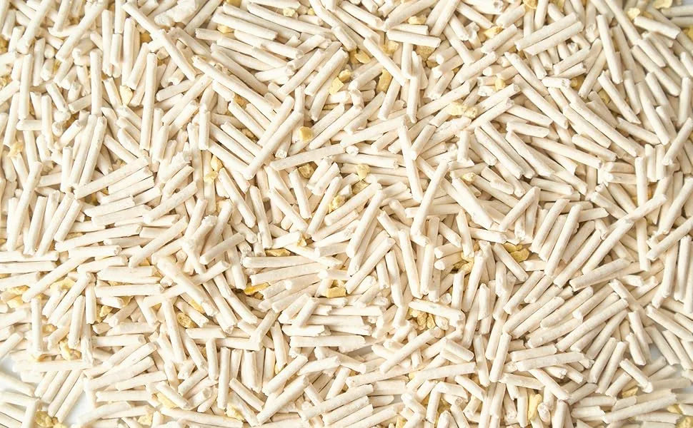 Close-up of Cococat Tofu 100% plant-based cat litter, showing light beige cylindrical pellets mixed with millet.