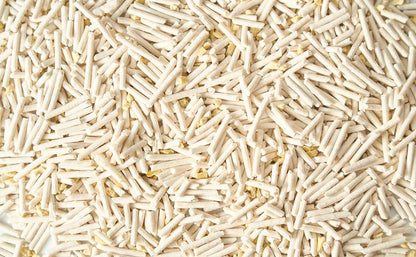 Close-up of Cococat Tofu 100% plant-based cat litter, showing light beige cylindrical pellets mixed with millet.