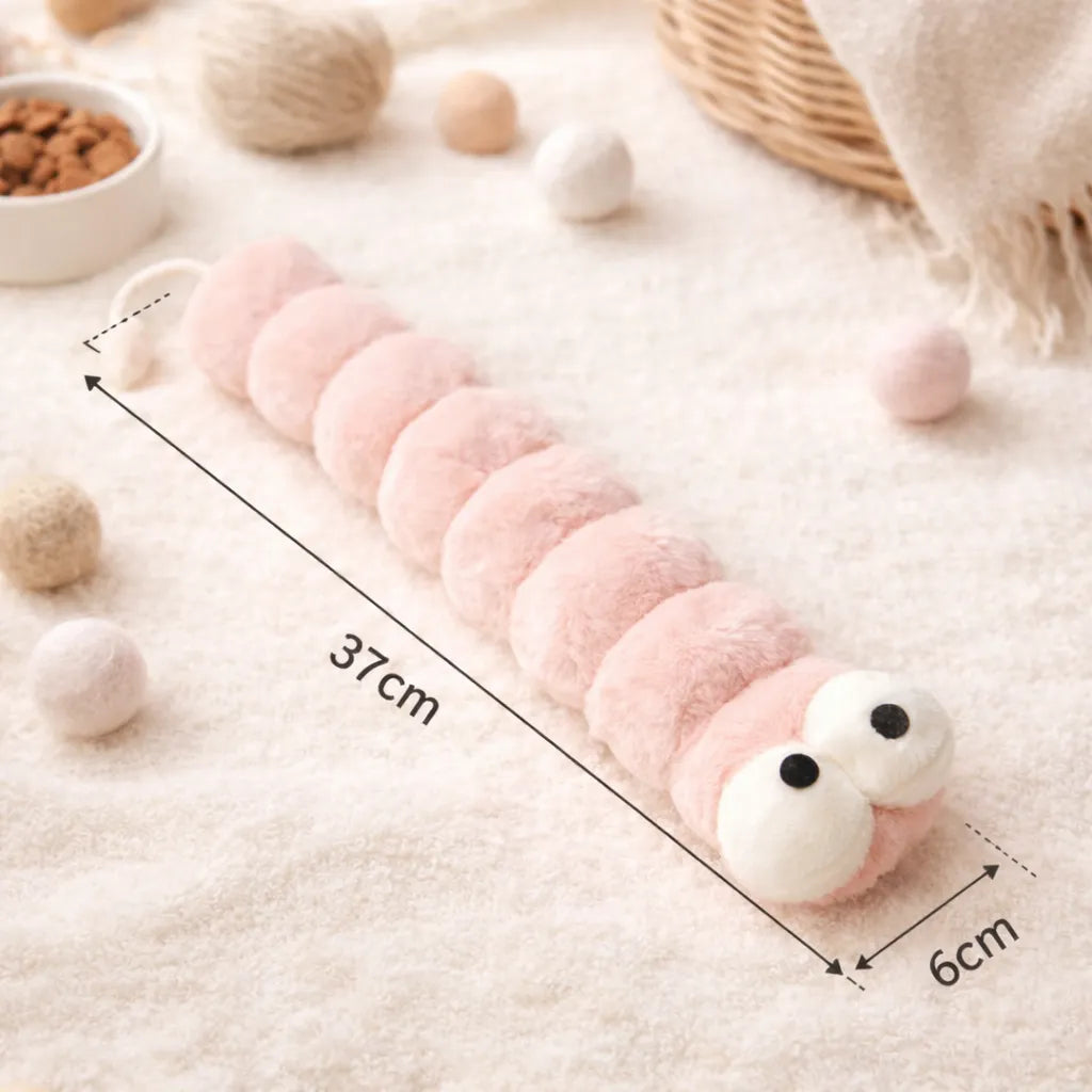 Pink plush caterpillar catnip kicker toy, 37cm long, with large white and black eyes.