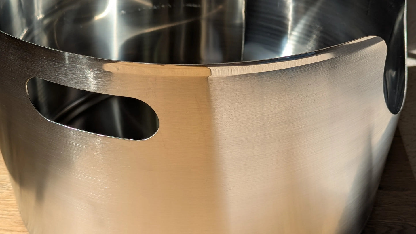 Sleek, round stainless steel Fussy Cat litter box with brushed finish and integrated side handles.
