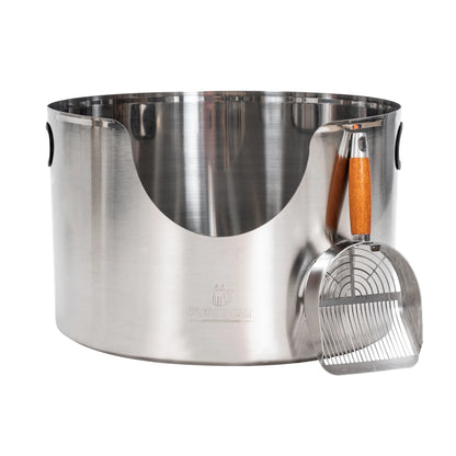 Fussy Cat Graded round stainless steel litter box with a matching metal scoop with a wooden handle.