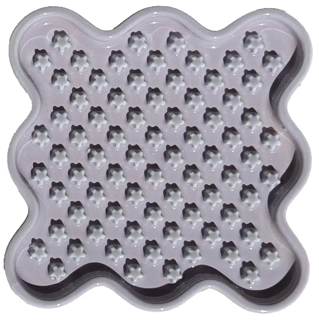 Light purple ceramic Fussy Cat slow feeder with wavy edges and star-shaped nubs.