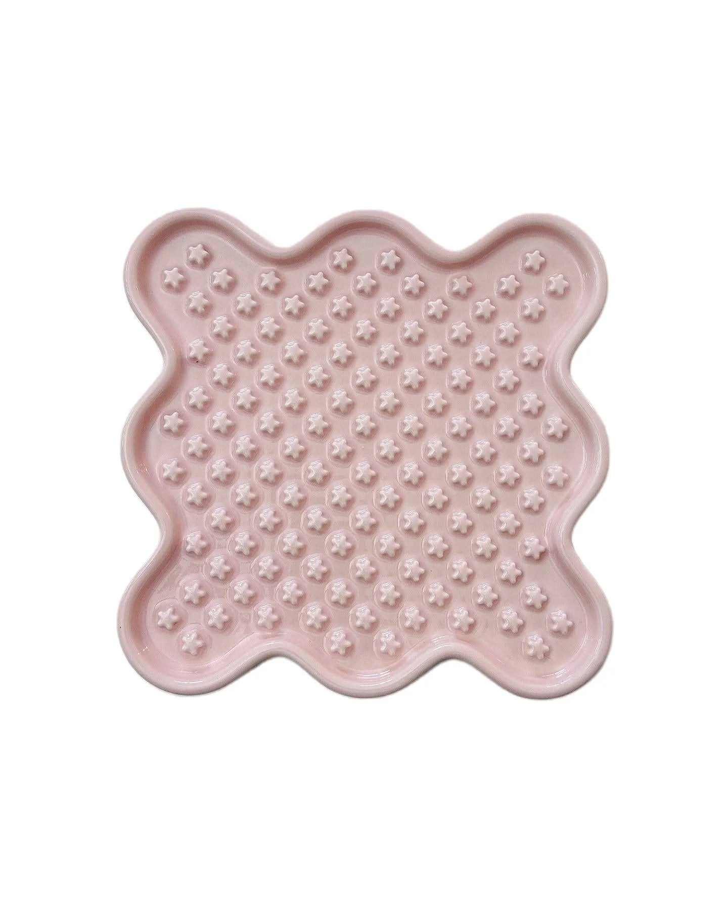 Pink ceramic Fussy Cat slow feeder with wavy edges and star-shaped nubs for healthy eating.