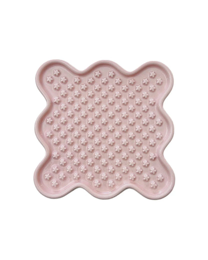 Pink ceramic Fussy Cat slow feeder with wavy edges and star-shaped nubs for healthy eating.