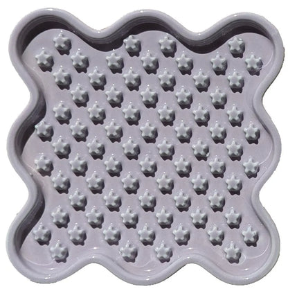 Lavender ceramic Fussy Cat slow feeder with a wavy edge and star-shaped food compartments.