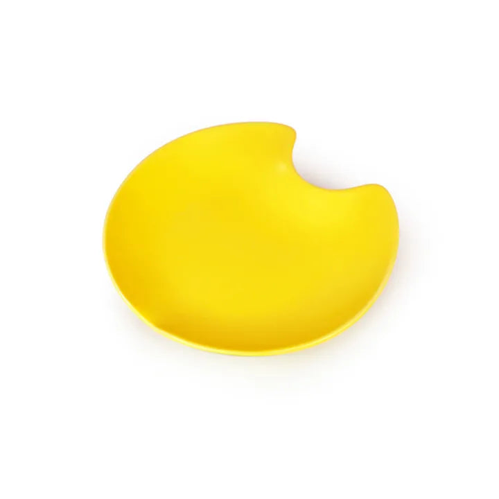 Bright yellow ceramic cat bowl with a unique, irregular, bite-shaped edge.