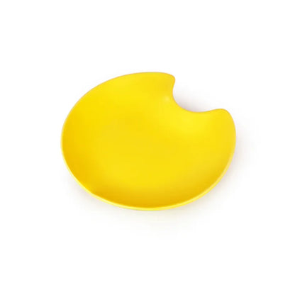 Bright yellow ceramic cat bowl with a unique, irregular, bite-shaped edge.