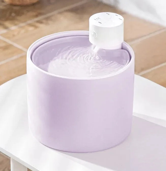 Fussy Cat wireless ceramic water fountain in light purple with a white pump, showing flowing water.