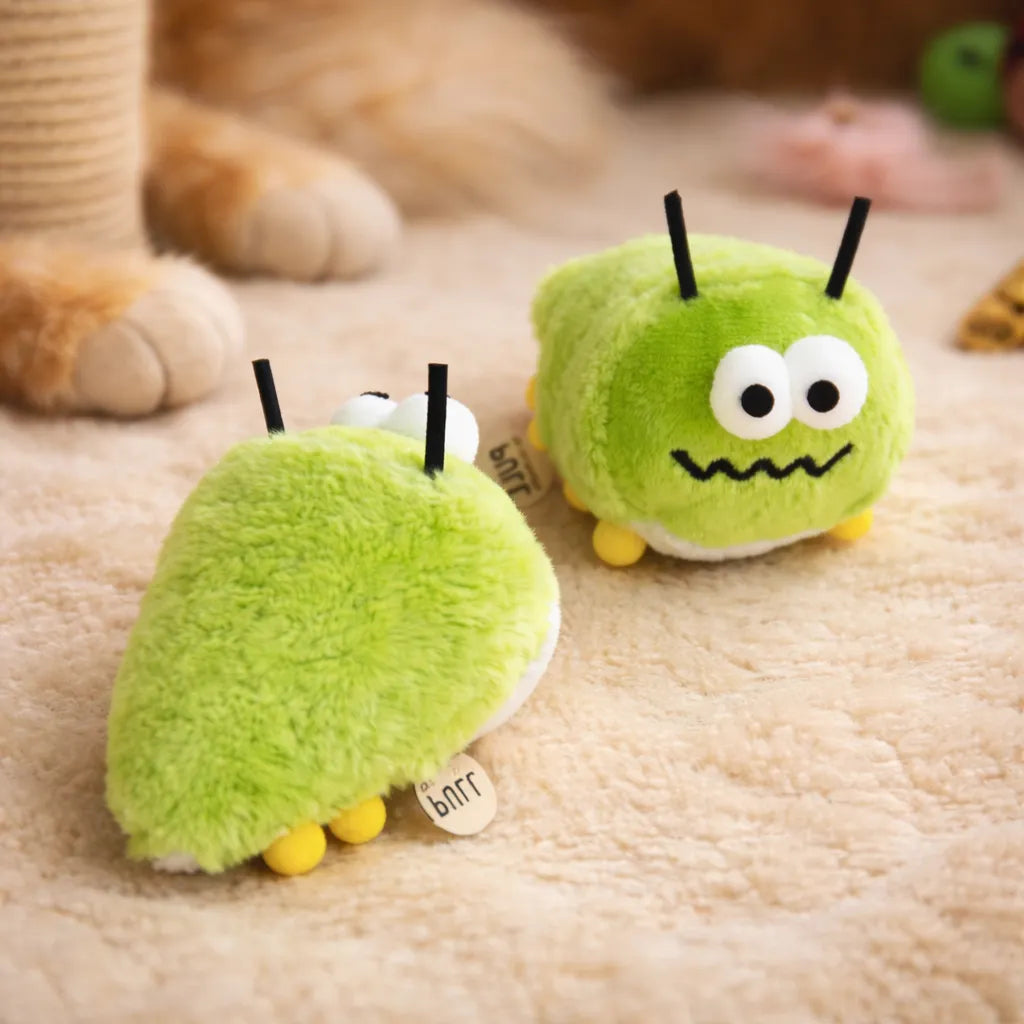 Two cute green plush bug catnip toys with black antennae and yellow feet on a beige carpet.