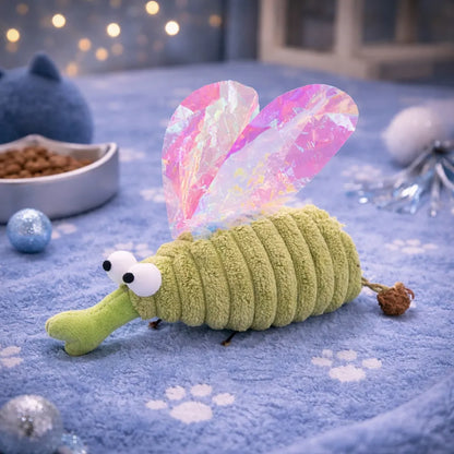 Green plush mosquito cat toy with iridescent wings and Matatabi fruit, on a blue paw-print blanket.