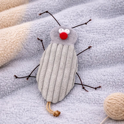Plush grey cockroach cat toy with red nose and antennae, on a soft blue blanket.