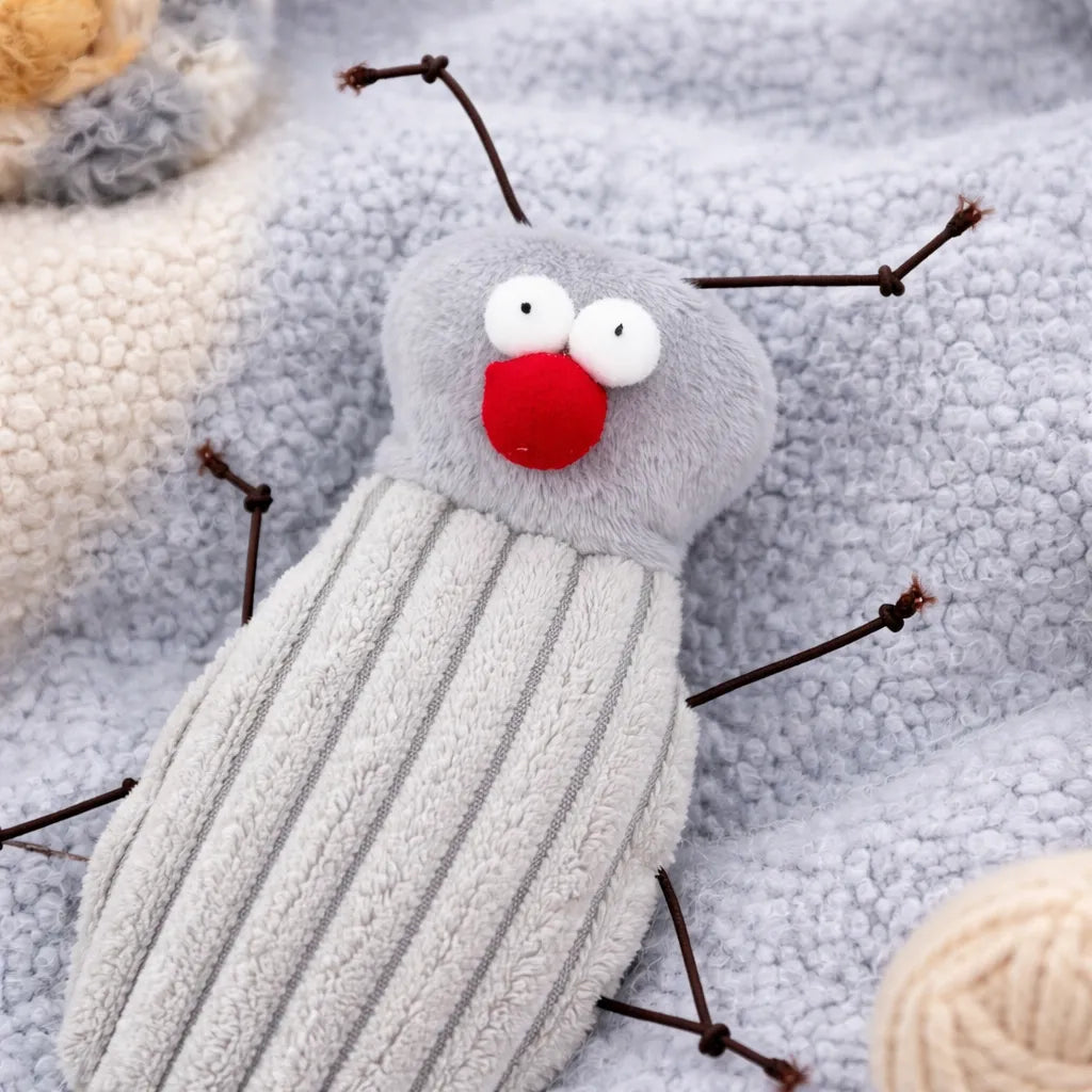 Plush grey cockroach cat toy with a red nose, white eyes, and brown wire legs on a soft blue blanket.