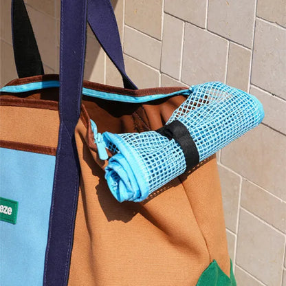 ZEZE canvas pet carrier in brown and turquoise with a rolled-up mesh window.